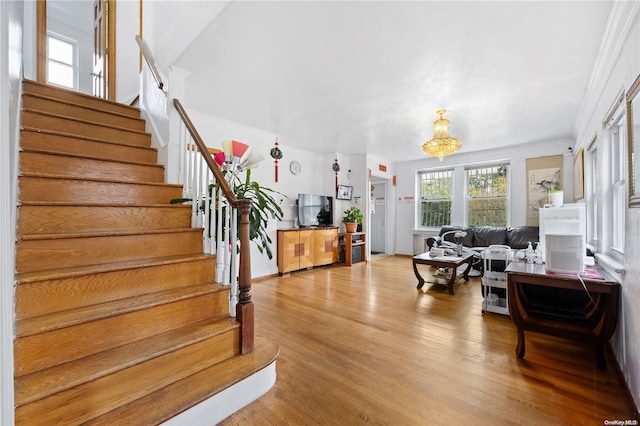 living room featuring light hardwood / wood-style flooring and crown molding