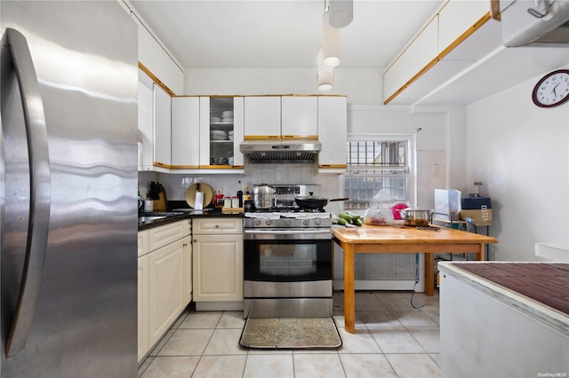 kitchen featuring appliances with stainless steel finishes, tasteful backsplash, and light tile patterned floors