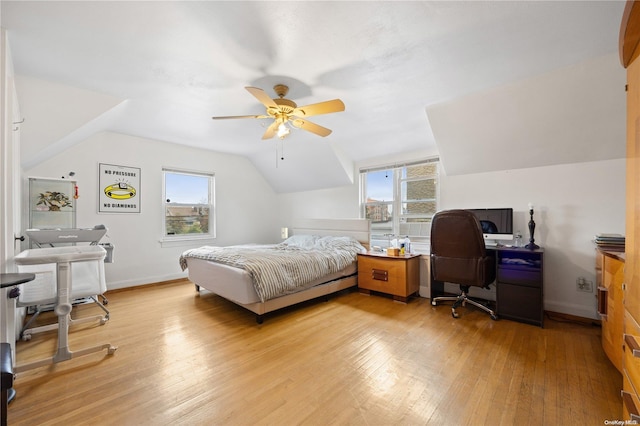 bedroom featuring multiple windows, ceiling fan, light hardwood / wood-style floors, and lofted ceiling