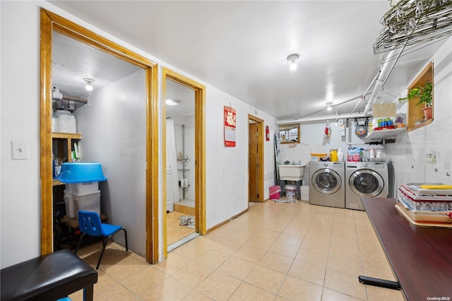 washroom featuring washer and clothes dryer and sink