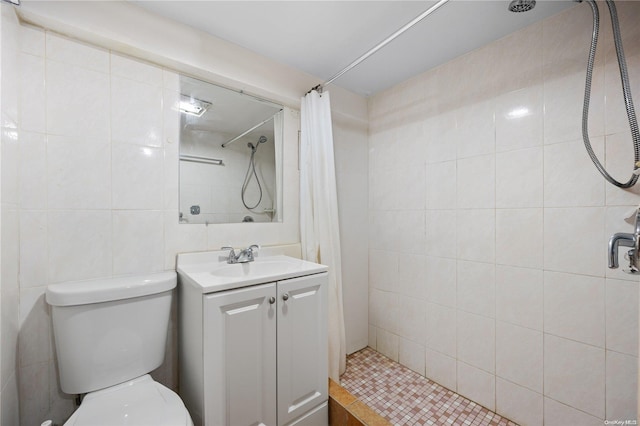 bathroom with a shower with curtain, vanity, tile walls, and toilet