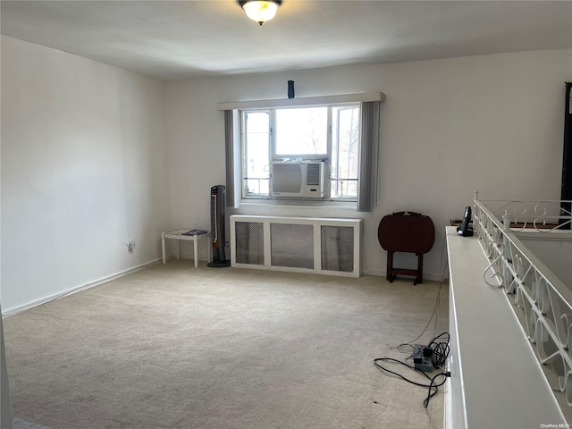 interior space featuring carpet floors, radiator, and cooling unit