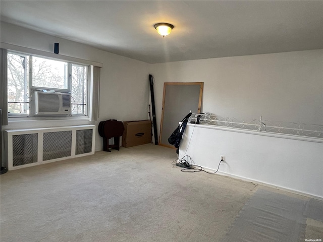 carpeted spare room with radiator and cooling unit