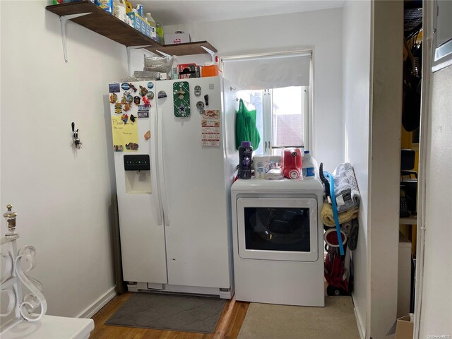 laundry room with wood-type flooring and washer / dryer