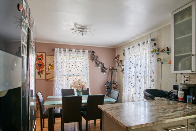 dining area featuring ceiling fan and wood-type flooring