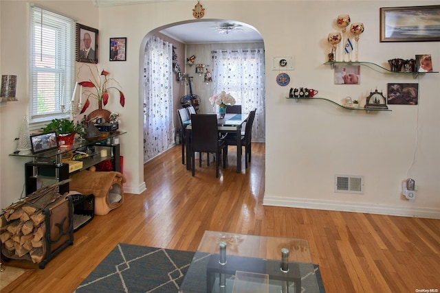 interior space with wood-type flooring and crown molding