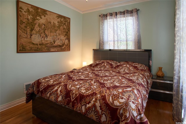 bedroom featuring dark hardwood / wood-style flooring and ornamental molding