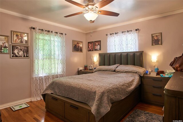 bedroom with dark hardwood / wood-style floors, ceiling fan, and ornamental molding