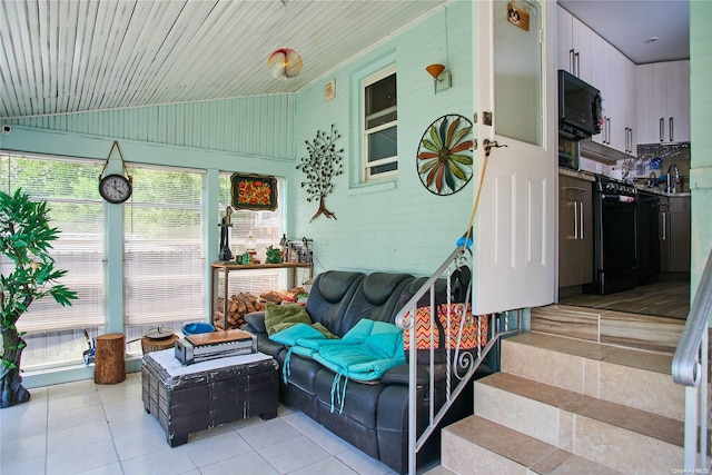 sunroom with a wealth of natural light, sink, wood ceiling, and lofted ceiling