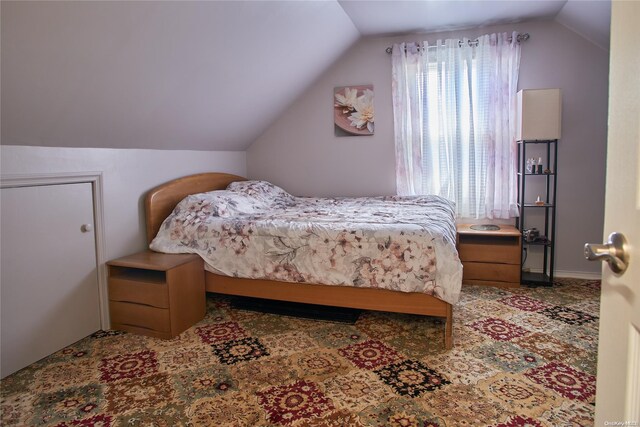 bedroom with carpet flooring and vaulted ceiling