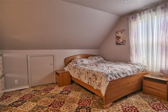 bedroom featuring lofted ceiling