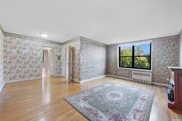 living room with hardwood / wood-style flooring and radiator heating unit