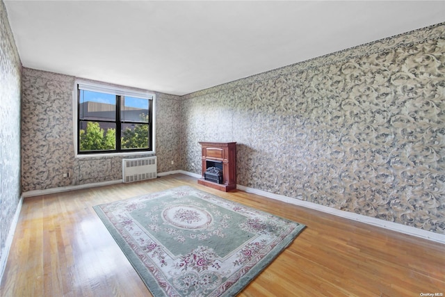 living room with hardwood / wood-style floors and radiator heating unit