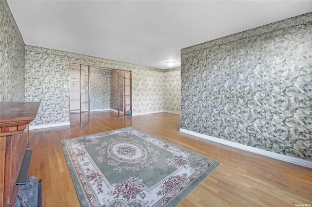 spare room featuring wood-type flooring