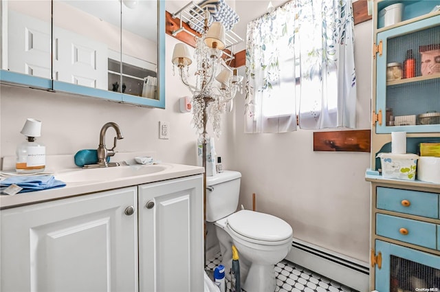 bathroom featuring vanity, toilet, baseboard heating, and an inviting chandelier