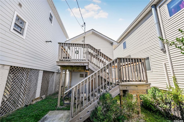 back of house featuring a wooden deck