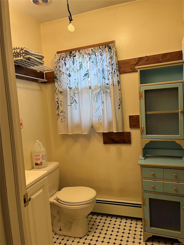 bathroom with vanity, a baseboard radiator, and toilet