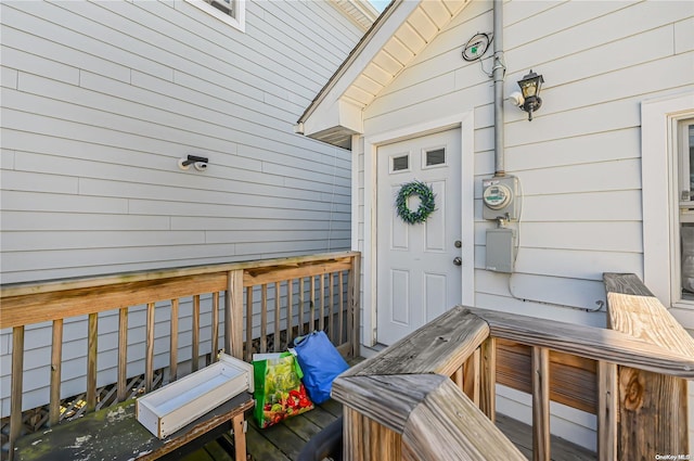 view of exterior entry with a wooden deck