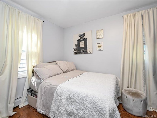 bedroom with dark hardwood / wood-style floors