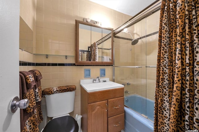 full bathroom featuring toilet, tiled shower / bath combo, tasteful backsplash, tile walls, and vanity