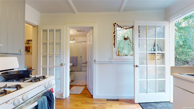 interior space with french doors, light hardwood / wood-style flooring, and crown molding