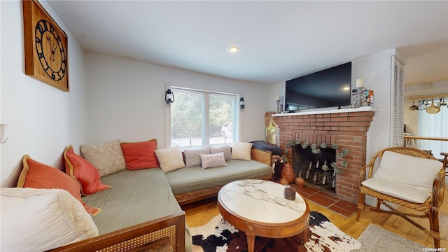 living room featuring a fireplace and light wood-type flooring