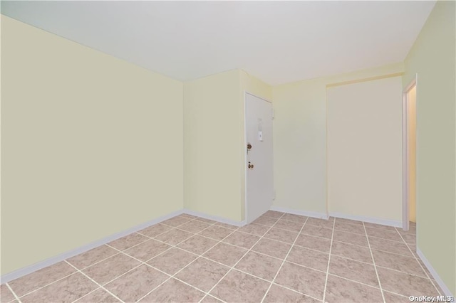 spare room with light tile patterned floors