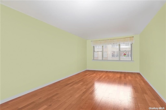 spare room with hardwood / wood-style floors