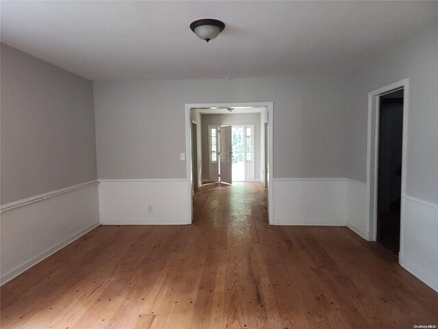 empty room with dark hardwood / wood-style flooring