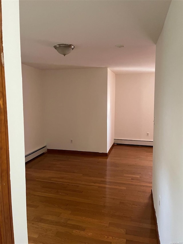 hall with a baseboard radiator and hardwood / wood-style flooring