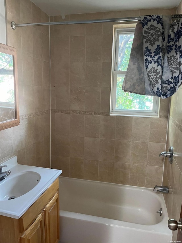 bathroom with vanity and tiled shower / bath combo