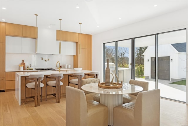 dining area featuring light wood-type flooring