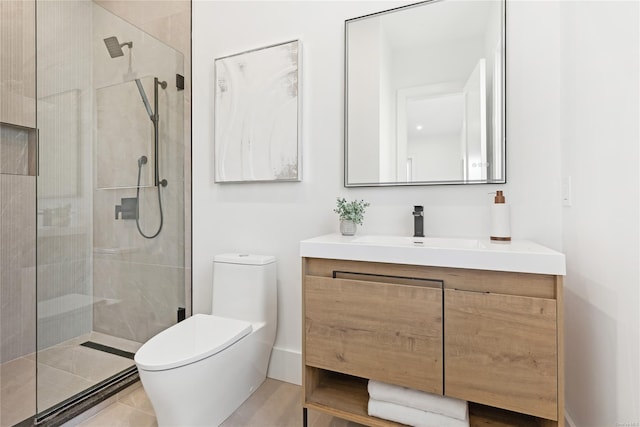 bathroom with tiled shower, vanity, toilet, and tile patterned flooring