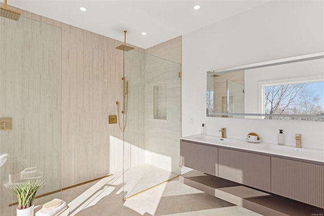 bathroom with a tile shower, tile patterned flooring, and vanity