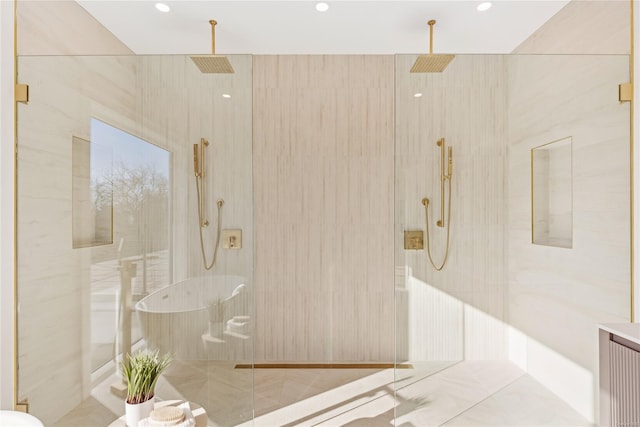 bathroom featuring tile patterned flooring and a tile shower