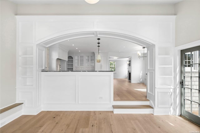 bar with white cabinetry, a wealth of natural light, pendant lighting, and light wood-type flooring