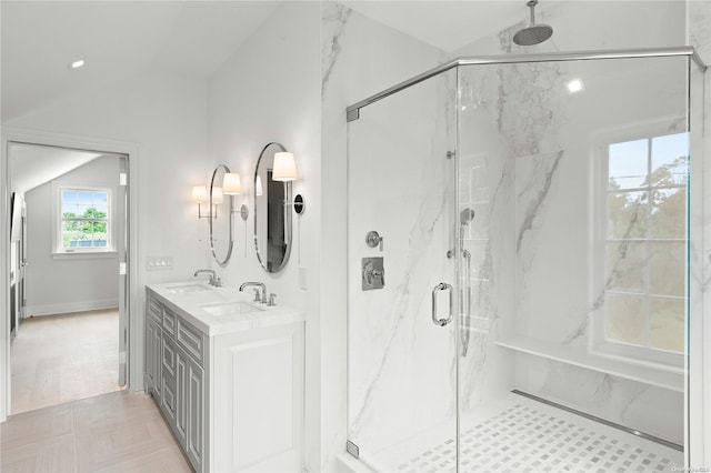 bathroom with vanity, a shower with shower door, and vaulted ceiling