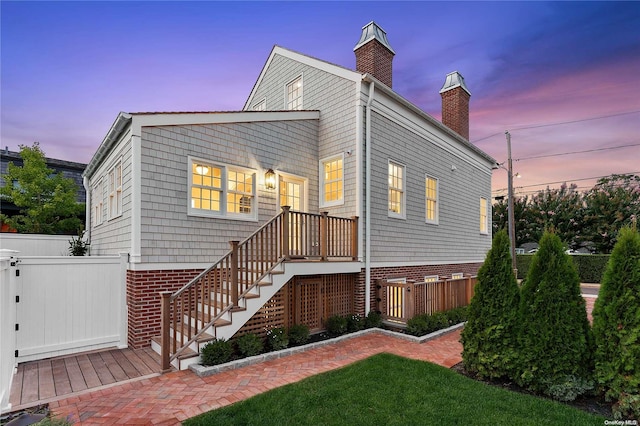 view of back house at dusk