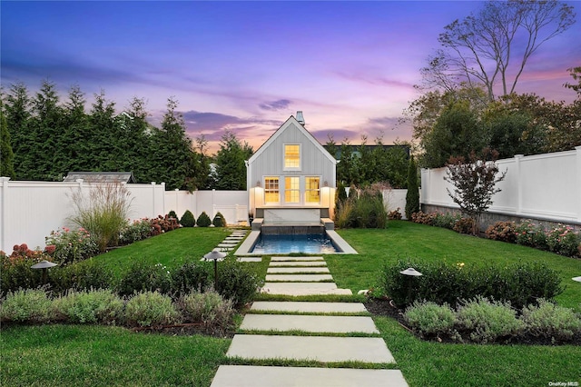 back house at dusk with a yard