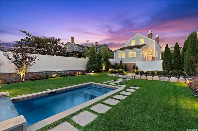 pool at dusk with a yard