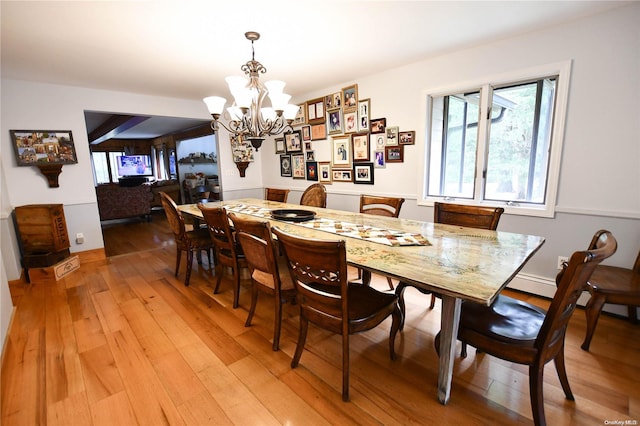 dining room featuring an inviting chandelier and hardwood / wood-style flooring