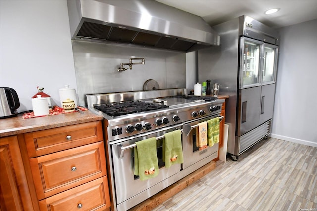 kitchen featuring exhaust hood and premium appliances