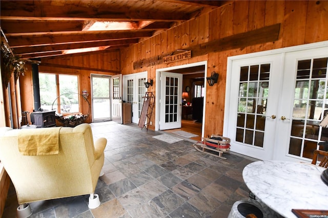 sunroom featuring french doors, lofted ceiling with beams, and wooden ceiling