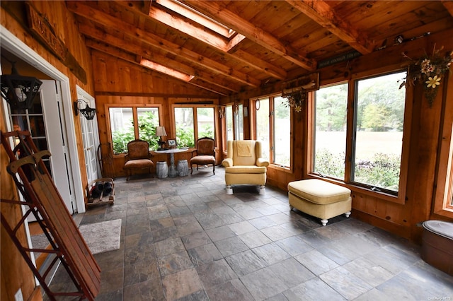 sunroom / solarium featuring vaulted ceiling with skylight and wood ceiling