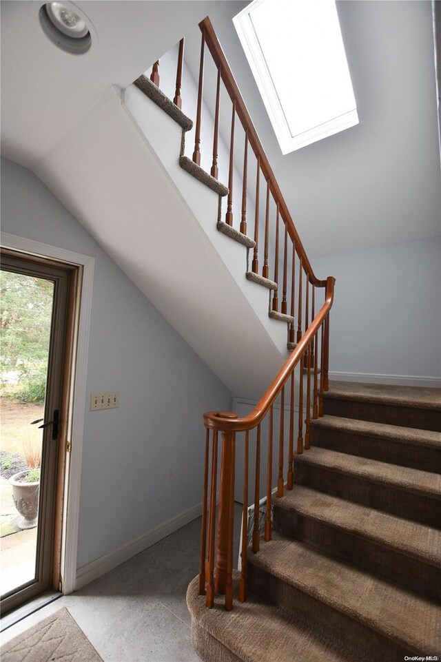 staircase featuring lofted ceiling