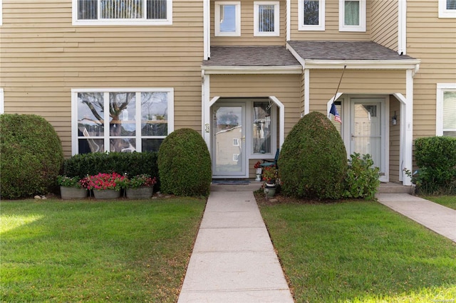 doorway to property featuring a yard