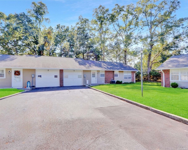 ranch-style house with a garage and a front lawn