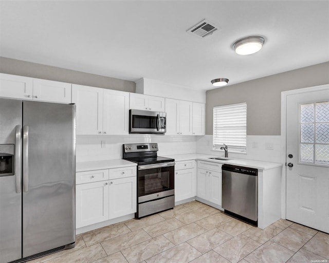 kitchen featuring sink, white cabinets, and stainless steel appliances