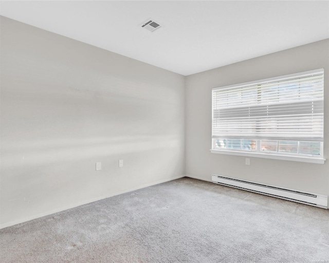 carpeted spare room with a baseboard radiator