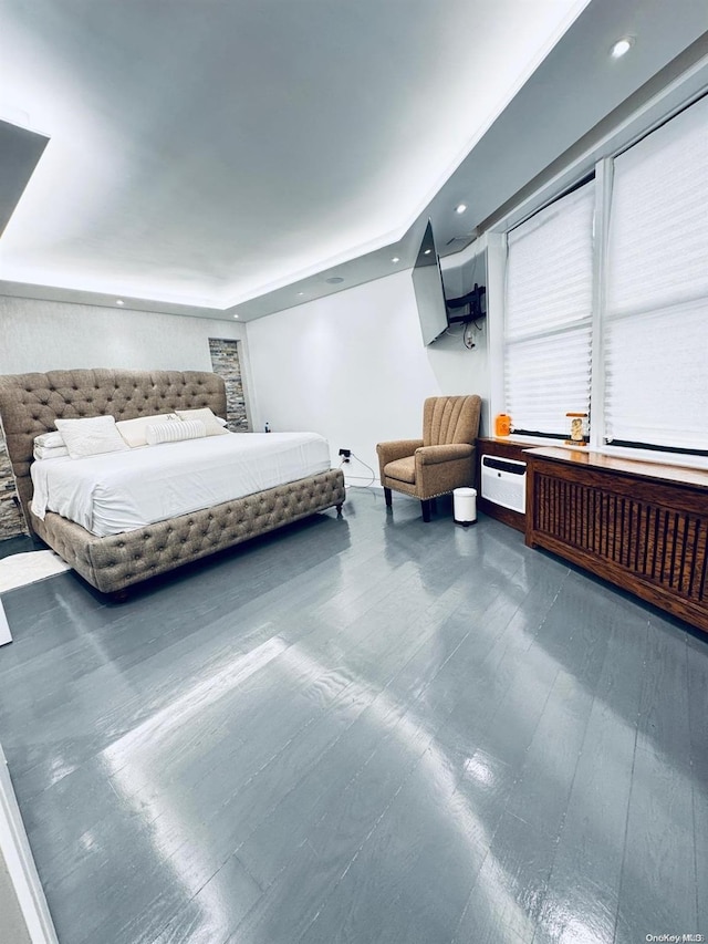 bedroom featuring radiator and hardwood / wood-style flooring